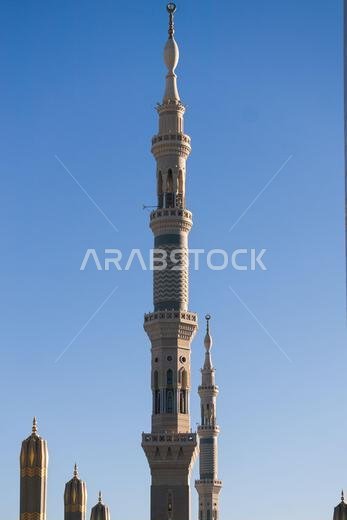 CIRCA MONTH YEAR: Towers of the Masjidil mosque againts blue sky in Mecca, Saudi Arabia.
