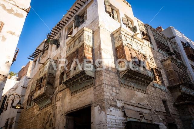 View of dilapidated residential houses in a typical side street in the historic district Al Balad, Jeddah, KSA, Saudi Arabia View of dilapidated residential houses in a typical side street in the historic district Al Balad, Jeddah, KSA, Saudi Arabia