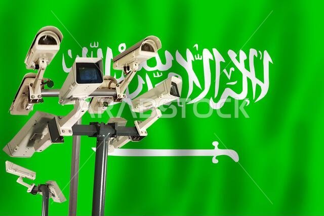 Saudi CCTV camera on the flag of Saudi Arabia Surveillance, security, control and totalitarianism concept
