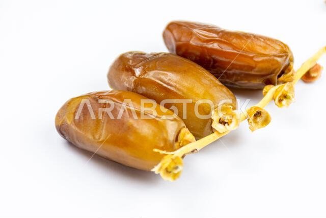 Close-up of Algerian royal dates on a white background. Ramadan concept.