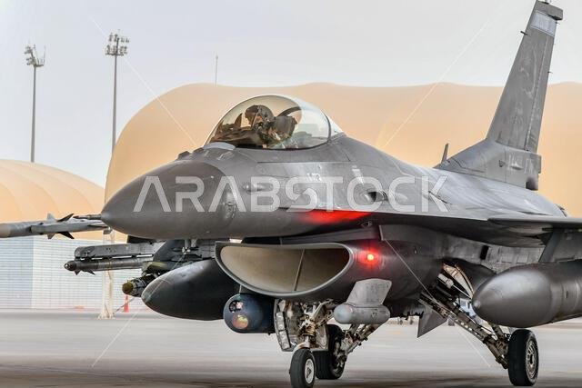 طائرة مقاتلة من طراز إف-16 سي إم فايتينغ فالكون بلوك 50 تابعة لسلاح الجو الأمريكي، والمخصصة للسرب المقاتل الاستكشافي 179، تتجه نحو المدرج في قاعدة الأمير سلطان الجوية، المملكة العربية السعودية، في 20 يونيو 2022. يُعنى السرب المقاتل الاستكشافي 179 بنشر القوة الجوية القتالية في جميع أنحاء منطقة مسؤولية القيادة المركزية للقوات الجوية الأمريكية، ودعم الأفراد، وتحسين حركة القوات، وإظهار عزم الولايات المتحدة والدول الشريكة في المنطقة. طائرة مقاتلة من طراز إف-16 سي إم فايتينغ فالكون بلوك 50 تابعة لسلاح الجو الأمريكي، والمخصصة للسرب المقاتل الاستكشافي 179، تتجه نحو المدرج في قاعدة الأمير سلطان الجوية، المملكة العربية السعودية، في 20 يونيو 2022. يُعنى السرب المقاتل الاستكشافي 179 بنشر القوة الجوية القتالية في جميع أنحاء منطقة مسؤولية القيادة المركزية للقوات الجوية الأمريكية، ودعم الأفراد، وتحسين حركة القوات، وإظهار عزم الولايات المتحدة والدول الشريكة في المنطقة.