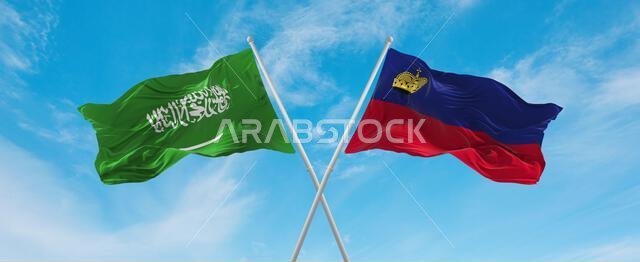 two crossed flags Liechtenstein and Saudi Arabia waving in wind at cloudy sky. Concept of relationship, dialog, travelling between two countries. 3d i