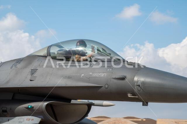 A U.S. Air Force Pilot assigned to the 77th Expeditionary Fighter Squadron poses for a photo in the cockpit of an F-16 Fighting Falcon aircraft, Jan. 9, 2023, at King Fahad Air Base, Kingdom of Saudi Arabia. The 378th Air Expeditionary Wing conduced this exercise in coordination with the Royal Saudi Air Force to ensure capabilities to rapidly deploy and operate throughout the U.S. Central Command area of responsibility.