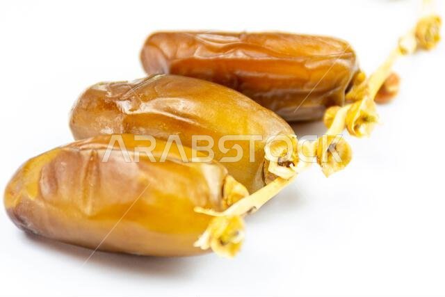 Close-up of Algerian royal dates on a white background. Ramadan concept.