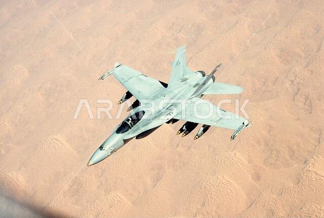 An F/A-18C Hornet aircraft of Strike-Fighter Squadron 81 (VFA-81), armed with bombs and AIM-9 Sidewinder missiles, prepares for refueling during Operation Desert Storm.. Subject Operation/Series: DESERT STORM Country: Saudi Arabia(SAU)