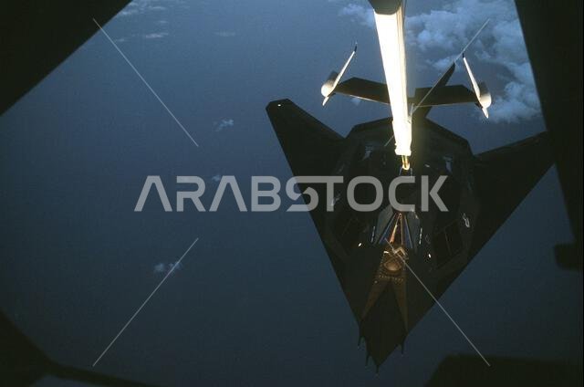 A 37th Tactical Fighter Wing F-117A Stealth fighter aircraft refuels from a 22nd Air Refueling Wing KC-10 Extender aircraft during Operation Desert Shield. The F-117A is en route to Saudi Arabia.. Subject Operation/Series: DESERT SHIELD Country: Unknown