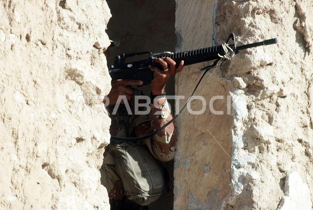 A soldier from Co. A, 3rd Bn., 502nd Inf. Regt., 101st Airborne Div., aims his M-16A2 rifle while taking part in an urban warfare training exercise in an abandoned town during Operation Desert Shield. Subject Operation/Series: DESERT SHIELD Country: Saudi Arabia(SAU)