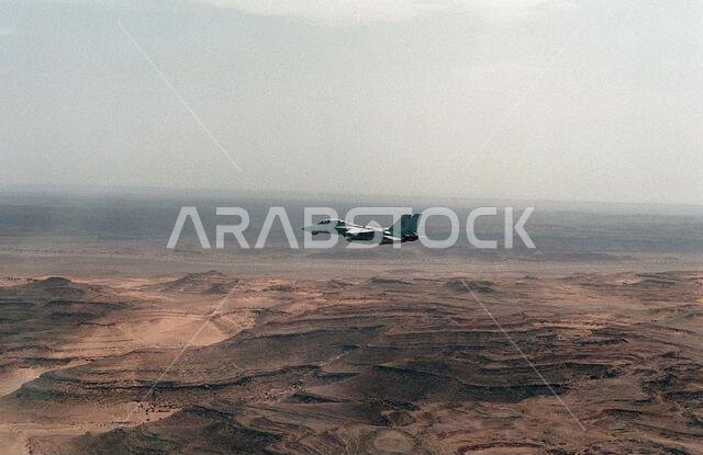 A Fighter Squadron 41 (VF-41) F-14A Tomcat aircraft flies over some hills during low-altitude training over western Saudi Arabia. VF-41 is embarked aboard the nuclear-powered aircraft carrier USS THEODORE ROOSEVELT (CVN-71).. Country: Saudi Arabia(SAU)