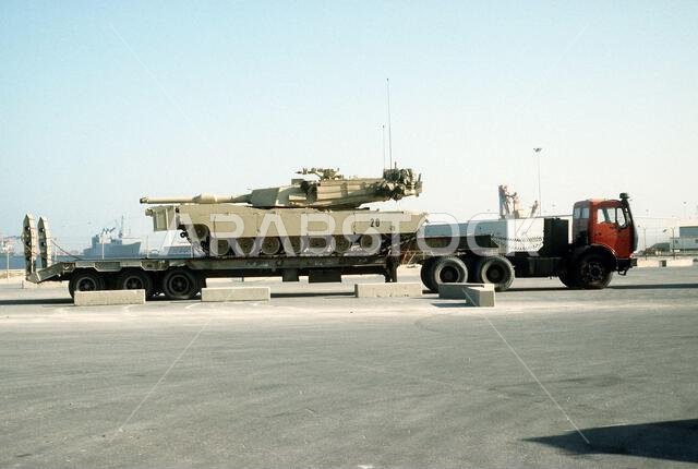 An M-1A1 Abrams main battle tank arrives on a Saudi transport truck during Operation Desert Shield. The M-1A1 will replace the older M-1 tank on the front line. Subject Operation/Series: DESERT SHIELD Country: Saudi Arabia(SAU)