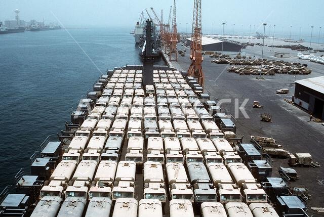 Oshkosh M-977 heavy expanded mobility tactical trucks are parked on the deck of a Military Sealift Command vehicle cargo ship for redeployment to the United States in the aftermath of Operation Desert Storm. Subject Operation/Series: DESERT STORM Country: Saudi Arabia (SAU)