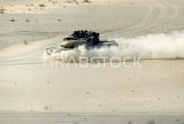 An M-1A1 Abrams main battle tank raises a cloud of dust as it crosses the desert during Operation Desert Shield. The M-1A1 will replace the older M-1 tank on the front line. Subject Operation/Series: DESERT SHIELD Country: Saudi Arabia(SAU)