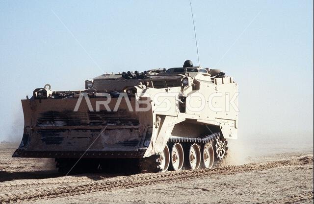 An M-9 Armored Combat Earthmover (ACE) assigned to the 2nd Marine Expeditionary Force moves toward the Kuwaiti border at the start of the ground phase of Operation Desert Storm. Subject Operation/Series: DESERT STORM Country: Saudi Arabia (SAU) An M-9 Armored Combat Earthmover (ACE) assigned to the 2nd Marine Expeditionary Force moves toward the Kuwaiti border at the start of the ground phase of Operation Desert Storm. Subject Operation/Series: DESERT STORM Country: Saudi Arabia (SAU)