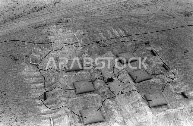 An aerial view of collapsible fuel storage reservoirs in a fuel storage area near Al-Kibrit used by U.S. forces during Operation Desert Storm. Subject Operation/Series: DESERT STORM Country: Saudi Arabia (SAU)