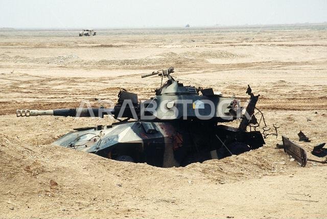 A battle-damaged Iraqi EE-9 Cascavel armored car remains buried in the sand north of Saudi Arabia during Operation Desert Storm. Subject Operation/Series: DESERT STORM Country: Iraq(IRQ)