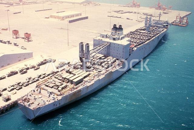 An Algol Class rapid-response vehicle cargo ship loaded with military equipment stands at the pier prior to departure. The equipment is being transported back to Germany in the aftermath of Operations Desert Shield/Desert Storm. Subject Operation/Series: DESERT SHIELD/DESERT STORM Base: Jubail Country: Saudi Arabia (SAU)