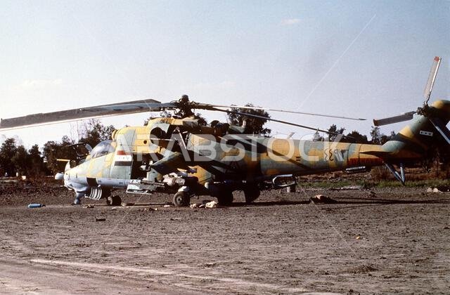 A captured Iraqi MIL Mi-24 helicopter stands at an 82nd Airborne Division encampment during Operation Desert Storm.. Subject Operation/Series: DESERT STORM Country: Saudi Arabia(SAU)