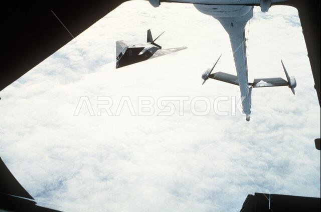 A 37th Tactical Fighter Wing F-117A Stealth fighter aircraft prepares to refuel from a 22nd Air Refueling Wing KC-10 Extender aircraft during Operation Desert Shield. The F-117A is en route to Saudi Arabia.. Subject Operation/Series: DESERT SHIELD Country: Unknown