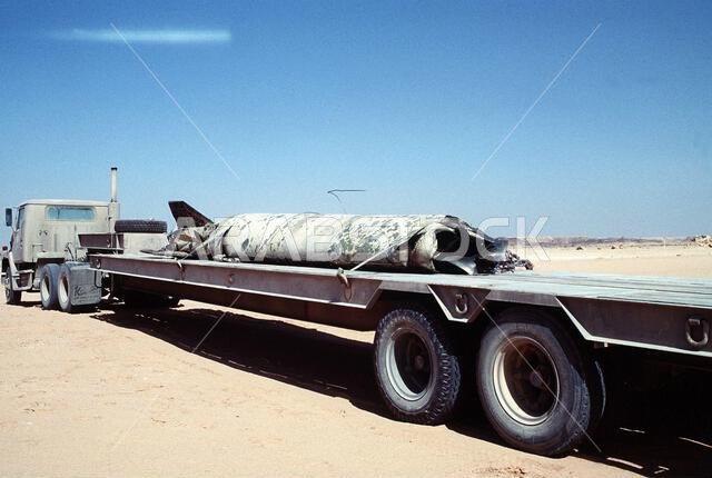 The remains of a Scud missile, shot down by an MIM-104 Patriot tactical air defense missile outside of Riyadh, are secured to a flatbed truck for transport during Operation Desert Storm. Subject Operation/Series: DESERT STORM Country: Saudi Arabia (SAU)