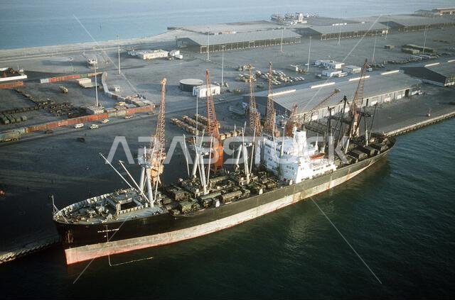 A port view of the vehicle cargo ship CLEVELAND loaded with equipment while moored to a pier during Operation Desert Shield. Subject Operation/Series: DESERT SHIELD Country: Saudi Arabia(SAU)