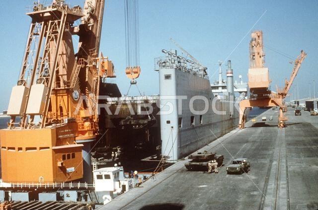 A crane lowers an M-1A1 Abrams main battle tank into the well deck of the Military Sealift Command-chartered freighter Cape Mendocino (T-AK-5064) as equipment is readied for transport to the Persian Gulf during Operation Desert Shield. Subject Operation/Series: DESERT SHIELD Country: Saudi Arabia(SAU) A crane lowers an M-1A1 Abrams main battle tank into the well deck of the Military Sealift Command-chartered freighter Cape Mendocino (T-AK-5064) as equipment is readied for transport to the Persian Gulf during Operation Desert Shield. Subject Operation/Series: DESERT SHIELD Country: Saudi Arabia(SAU)