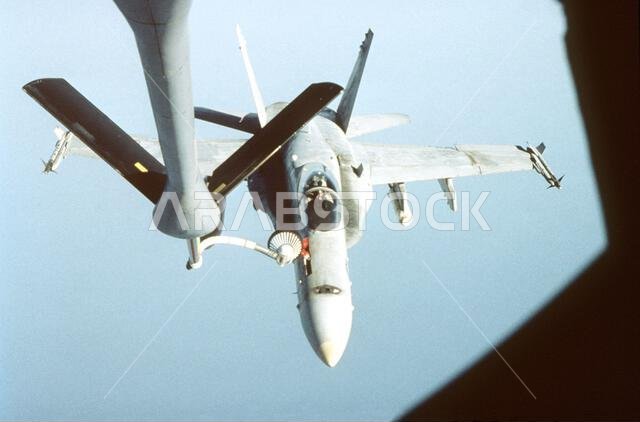 A top-down view of an F/A-18 from the USS Carl Vinson (CVN-70) as it hooks into the drogue receptacle and begins to receive fuel. A KC-135 from the 4408 Air Refueling Squadron, 4409 Air Wing (Provisional) conducted the first operational mission since the start of the relocation of Operation Southern Watch/Operation Desert Focus. Subject Operation/Series: DESERT FOCUS Base: Prince Sultan Air Base Country: Saudi Arabia (SAU)