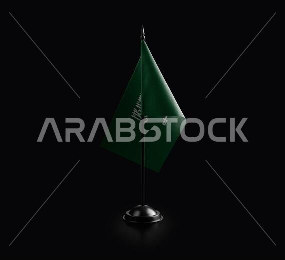 Small national flag of the Saudi Arabia on a black background.