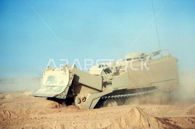 A soldier of Co. B, 5th Engineers, attached to the 3rd Engineers, 24th Infantry Division, practice using an M-9 armored combat earthmover during Operation Desert Storm. Subject Operation/Series: DESERT STORM Country: Saudi Arabia(SAU) A soldier of Co. B, 5th Engineers, attached to the 3rd Engineers, 24th Infantry Division, practice using an M-9 armored combat earthmover during Operation Desert Storm. Subject Operation/Series: DESERT STORM Country: Saudi Arabia(SAU)
