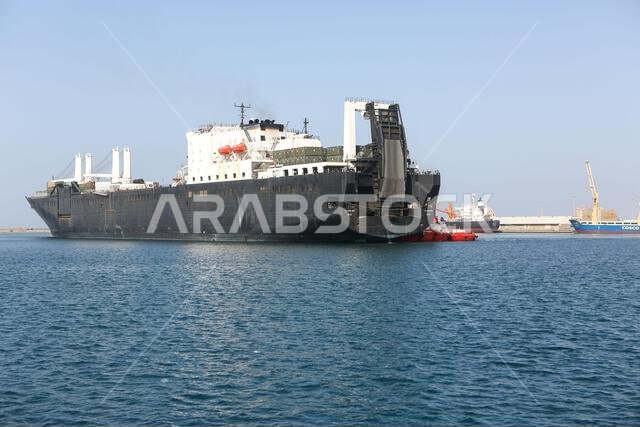 US. Naval Ship Seay (T–AKR-302) is pushed by Yanbu Commercial Port boats during exercise Native Fury 22 at Yanbu Commercial Port, Kingdom of Saudi Arabia, Aug. 24, 2022. Native Fury 22 is a biennial exercise focused on the demonstration of the rapid offload and integration of a Maritime Prepositioned Force in the U.S. Central Command area of responsibility in support of regional security, crisis response, and contingency operations. KSA,MARCENT,NATIVEFURY22,Saudi Arabia,U.S. Marine Corps Forces US. Naval Ship Seay (T–AKR-302) is pushed by Yanbu Commercial Port boats during exercise Native Fury 22 at Yanbu Commercial Port, Kingdom of Saudi Arabia, Aug. 24, 2022. Native Fury 22 is a biennial exercise focused on the demonstration of the rapid offload and integration of a Maritime Prepositioned Force in the U.S. Central Command area of responsibility in support of regional security, crisis response, and contingency operations. KSA,MARCENT,NATIVEFURY22,Saudi Arabia,U.S. Marine Corps Forces