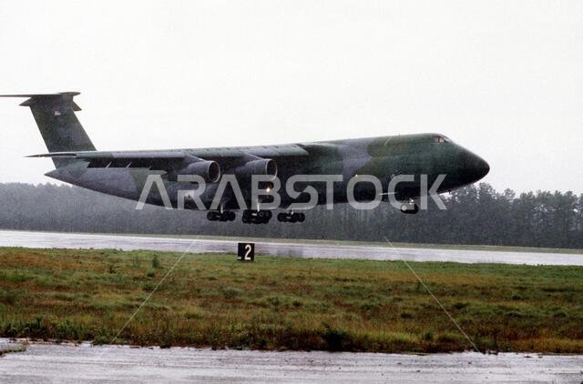 A C-5A Galaxy aircraft takes off in the rain as it deploys to Saudi Arabia during Operation Desert Shield. Subject Operation/Series: DESERT SHIELD Country: Unknown A C-5A Galaxy aircraft takes off in the rain as it deploys to Saudi Arabia during Operation Desert Shield. Subject Operation/Series: DESERT SHIELD Country: Unknown