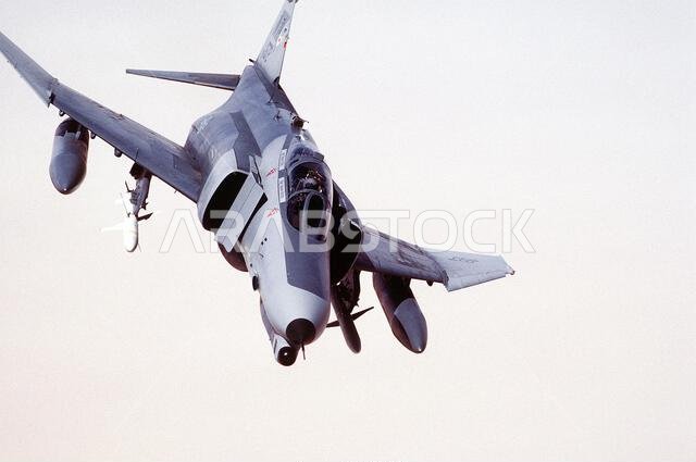 A 35th Tactical Fighter Wing F-4G Phantom II aircraft banks to the left while on a training flight during Operation Desert Shield. The aircraft is carrying external fuel tanks on its outboard wing pylons and AGM-88 HARM high-speed anti-radiation missiles on its inboard wing pylons. The aircraft's aerial refueling port, located behind the cockpit, is open. Subject Operation/Series: DESERT SHIELD Country: Saudi Arabia (SAU) A 35th Tactical Fighter Wing F-4G Phantom II aircraft banks to the left while on a training flight during Operation Desert Shield. The aircraft is carrying external fuel tanks on its outboard wing pylons and AGM-88 HARM high-speed anti-radiation missiles on its inboard wing pylons. The aircraft's aerial refueling port, located behind the cockpit, is open. Subject Operation/Series: DESERT SHIELD Country: Saudi Arabia (SAU)
