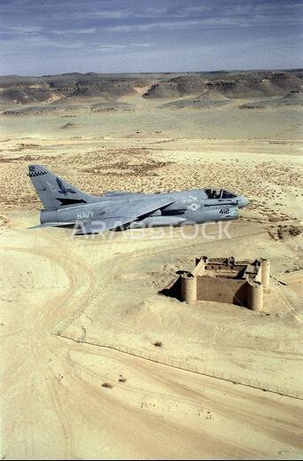 An Attack Squadron 72 (VA-72) A-7E Corsair aircraft passes over a ruined fort in the Saudi desert during low-level training. VA-72 is deployed aboard the aircraft carrier USS JOHN F. KENNEDY (CV-67), which is on station in the Red Sea in support of Operation Desert Shield. Subject Operation/Series: DESERT SHIELD Country: Saudi Arabia (SAU)