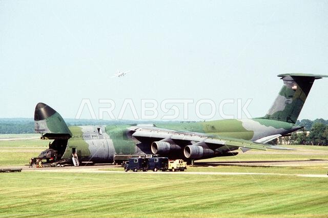 A UH-60 Black Hawk (Blackhawk) helicopter is loaded aboard a 709th Military Airlift Squadron C-5A Galaxy aircraft as the plane prepares to transport equipment to Saudi Arabia during Operation Desert Shield. Subject Operation/Series: DESERT SHIELD Base: Fort Bragg State: North Carolina (NC) Country: United States Of America (USA) A UH-60 Black Hawk (Blackhawk) helicopter is loaded aboard a 709th Military Airlift Squadron C-5A Galaxy aircraft as the plane prepares to transport equipment to Saudi Arabia during Operation Desert Shield. Subject Operation/Series: DESERT SHIELD Base: Fort Bragg State: North Carolina (NC) Country: United States Of America (USA)