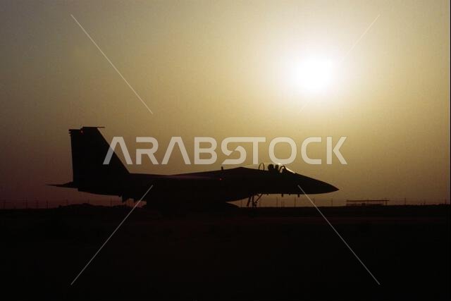 A 1ST Tactical Fighter Squadron F-15C Eagle aircraft is silhouetted against the sky as it taxis along a runway during Operation Desert Shield. Subject Operation/Series: DESERT SHIELD Country: Saudi Arabia (SAU)