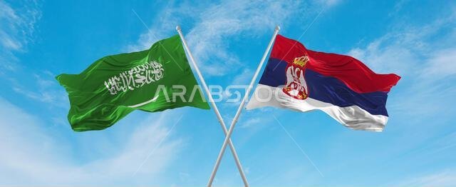 علمان متقاطعان، علم صربيا وعلم السعودية، يرفرفان في مهب الريح تحت سماء ملبدة بالغيوم. يرمز هذا العمل الفني إلى مفهوم العلاقة والحوار والسفر بين البلدين. رسم ثلاثي الأبعاد.
