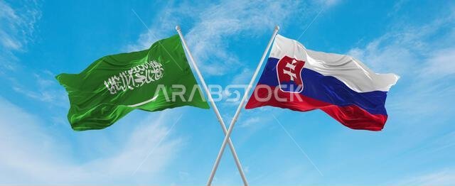 two crossed flags Slovakia and Saudi Arabia waving in wind at cloudy sky. Concept of relationship, dialog, travelling between two countries. 3d illust