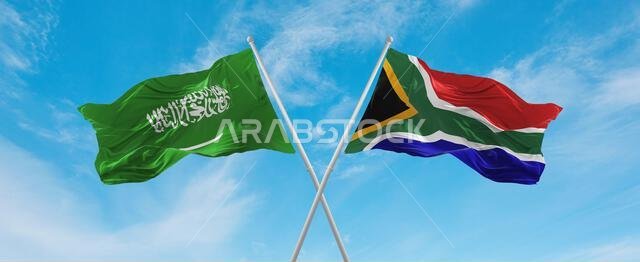علمان متقاطعان، علم جنوب أفريقيا وعلم المملكة العربية السعودية، يرفرفان في مهب الريح تحت سماء ملبدة بالغيوم. يرمز هذا العمل الفني إلى مفهوم العلاقة والحوار والسفر بين البلدين. رسم ثلاثي الأبعاد علمان متقاطعان، علم جنوب أفريقيا وعلم المملكة العربية السعودية، يرفرفان في مهب الريح تحت سماء ملبدة بالغيوم. يرمز هذا العمل الفني إلى مفهوم العلاقة والحوار والسفر بين البلدين. رسم ثلاثي الأبعاد