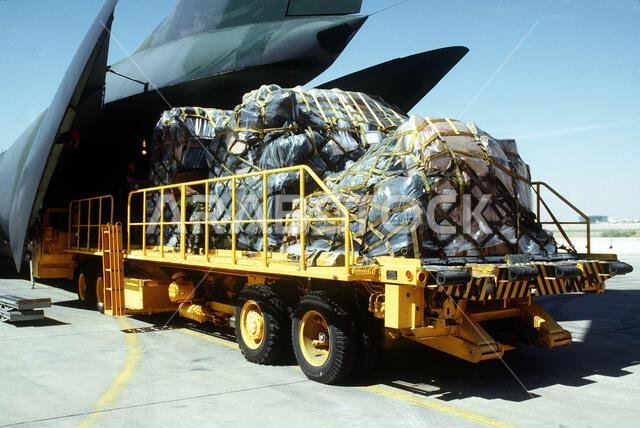 U.S. military personnel load supplies from a K-loader onto a C-141B Starlifter aircraft for deployment to Saudi Arabia in support of Operation Desert Shield. Subject Operation/Series: DESERT SHIELD Country: Unknown U.S. military personnel load supplies from a K-loader onto a C-141B Starlifter aircraft for deployment to Saudi Arabia in support of Operation Desert Shield. Subject Operation/Series: DESERT SHIELD Country: Unknown