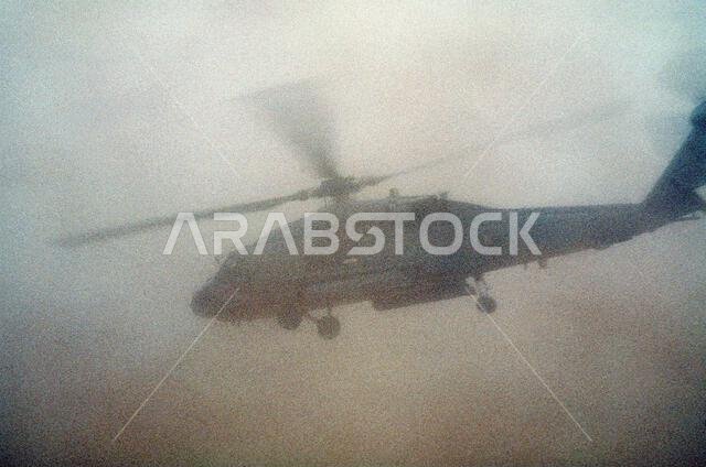 An HH-60H Sea Hawk helicopter from Helicopter Combat Search and Rescue/Special Warfare Support Squadron 4 (HCS-4) of Norfolk, Va., takes off in the sand for a search and rescue mission at the start of Operation Desert Storm.. Subject Operation/Series: DESERT STORM Country: Saudi Arabia(SAU)