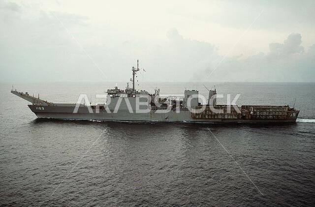 A port beam view of the tank landing ship USS SAN BERNARDINO (LST-1189) as the vessel deploys to the Middle East to take part in Operation Desert Shield. Subject Operation/Series: DESERT SHIELD Base: USS San Bernardino (LST 1189) Country: Atlantic Ocean (AOC)