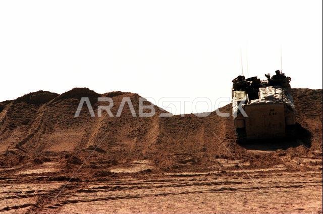 An AAVP-7A1 assault amphibian vehicle passes through a hole blasted in a berm by members of the 2nd Combat Engineer Battalion, Task Force Alpha, during Operation Desert Storm. Subject Operation/Series: DESERT STORM Country: Saudi Arabia (SAU)