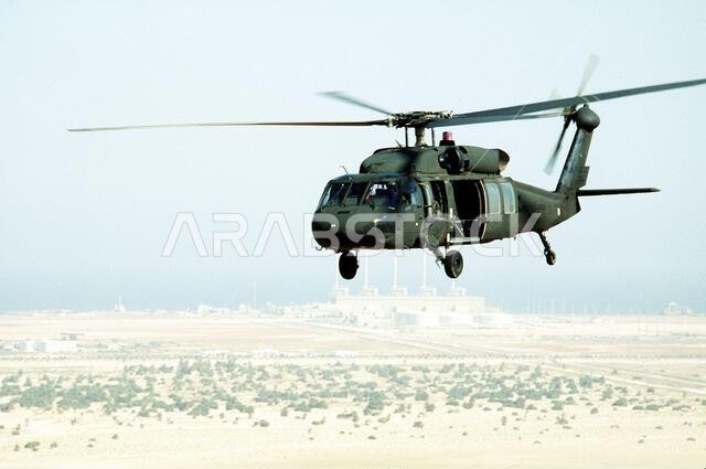 A UH-60 Black Hawk (Blackhawk) helicopter from Co. B, 2nd Bn., 82nd Airborne Div. conducts a resupply mission near the Kuwait border during Operation Desert Shield. Subject Operation/Series: DESERT SHIELD Country: Saudi Arabia (SAU) A UH-60 Black Hawk (Blackhawk) helicopter from Co. B, 2nd Bn., 82nd Airborne Div. conducts a resupply mission near the Kuwait border during Operation Desert Shield. Subject Operation/Series: DESERT SHIELD Country: Saudi Arabia (SAU)