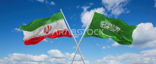 two crossed flags Saudi Arabia and Iran waving in wind at cloudy sky. Concept of relationship, dialog, travelling between two countries. 3d illustrati