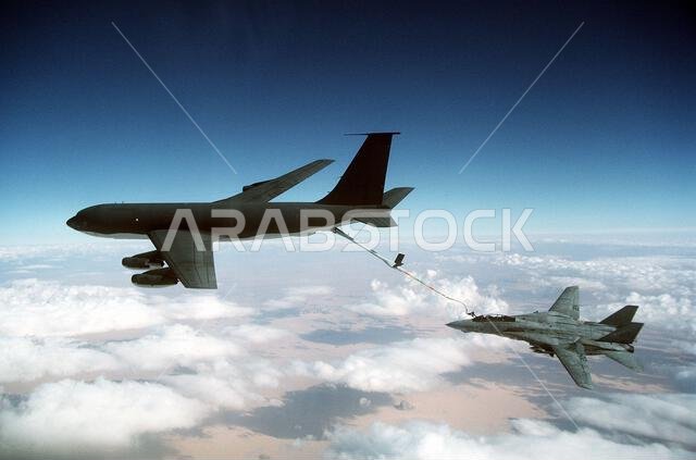A Fighter Squadron 32 (VF-32) F-14A Tomcat aircraft is refueled by a U.S. Air Force KC-135E Stratotanker aircraft during Operation Desert Storm. VF-32 is based aboard the aircraft carrier USS JOHN F. KENNEDY (CV-67). Subject Operation/Series: DESERT STORM Country: Saudi Arabia (SAU)