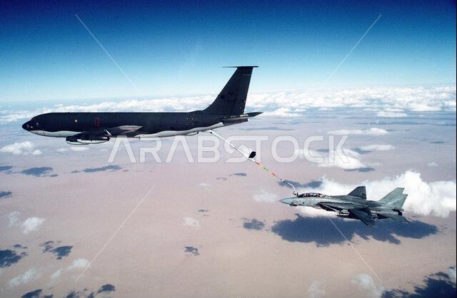 A Fighter Squadron 32 (VF-32) F-14A Tomcat aircraft is refueled by a U.S. Air Force KC-135E Stratotanker aircraft during Operation Desert Storm. VF-32 is based aboard the aircraft carrier USS JOHN F. KENNEDY (CV-67). Subject Operation/Series: DESERT STORM Country: Saudi Arabia (SAU)