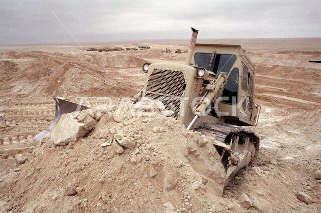 A member of Naval Mobile Construction Battalion 5 uses a bulldozer to prepare the area for camp during Operation Desert Storm. Exact Date Shot Unknown. Subject Operation/Series: DESERT STORM Country: Saudi Arabia (SAU)