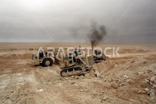 Members of Naval Mobile Construction Battalion 5 operate bulldozers and scrapers as they prepare the area for camp during Operation Desert Storm. Exact Date Shot Unknown. Subject Operation/Series: DESERT STORM Country: Saudi Arabia (SAU)