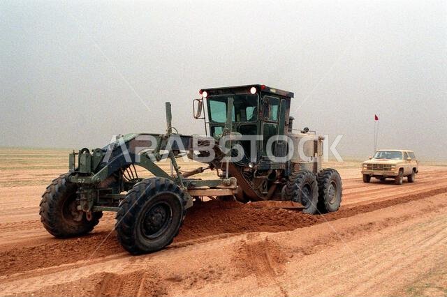 A road grader used by members of a Naval Mobile Construction Battalion stands on a main supply route during Operation Desert Storm. Subject Operation/Series: DESERT STORM Country: Saudi Arabia (SAU)