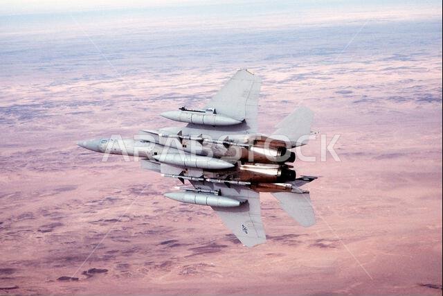 A 58th Tactical Fighter Squadron F-15 Eagle aircraft banks to the right following refueling during Operation Desert Storm. The aircraft is armed with four AIM-7 Sparrow missiles on the fuselage, an AIM-9 Sidewinder missile on the left wing and an AIM-120 advanced medium range air-to-air missile on the right wing. Subject Operation/Series: DESERT STORM Country: Saudi Arabia(SAU)