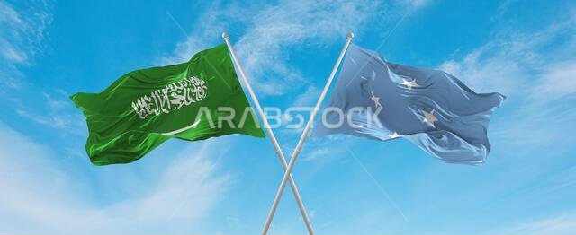 two crossed flags Micronesia Federated States and Saudi Arabia waving in wind at cloudy sky. Concept of relationship, dialog, travelling between two c