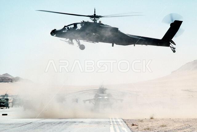 An AH-64 Apache helicopter lifts off as the 82nd Aviation Brigade relocates in the desert during Operation Desert Shield.. Subject Operation/Series: DESERT SHIELD Country: Saudi Arabia(SAU)